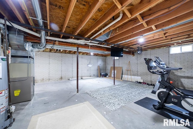 basement featuring heating unit and gas water heater