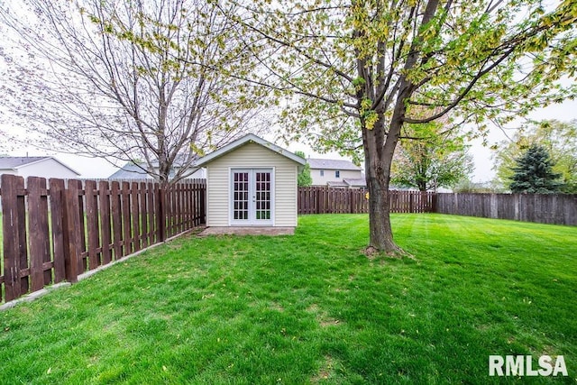 view of yard with french doors and a fenced backyard