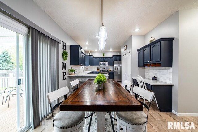 dining area featuring recessed lighting, baseboards, and light wood-style floors