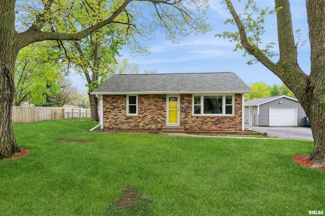 ranch-style house featuring fence, brick siding, a shingled roof, an outbuilding, and a detached garage
