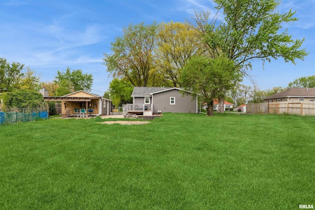 view of yard with fence and a wooden deck