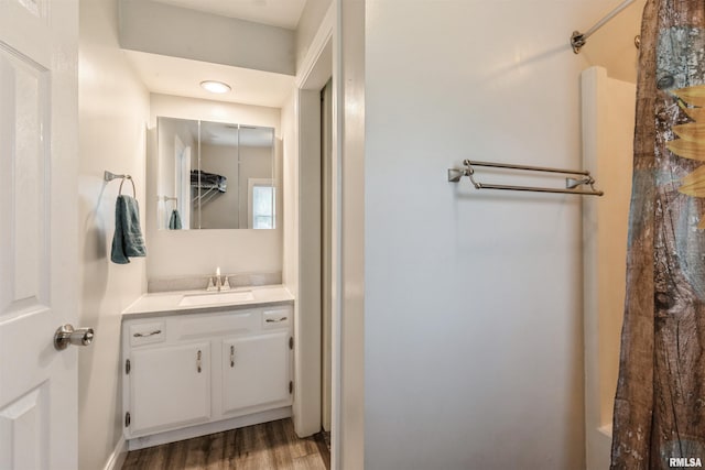 full bathroom featuring a shower, vanity, and wood finished floors