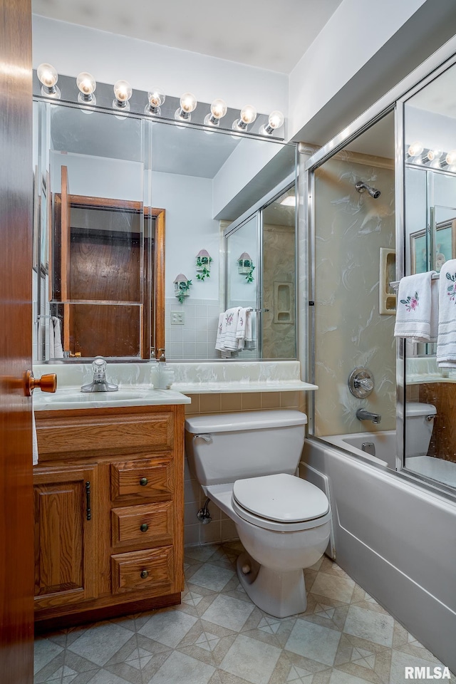 full bath featuring toilet, enclosed tub / shower combo, and vanity