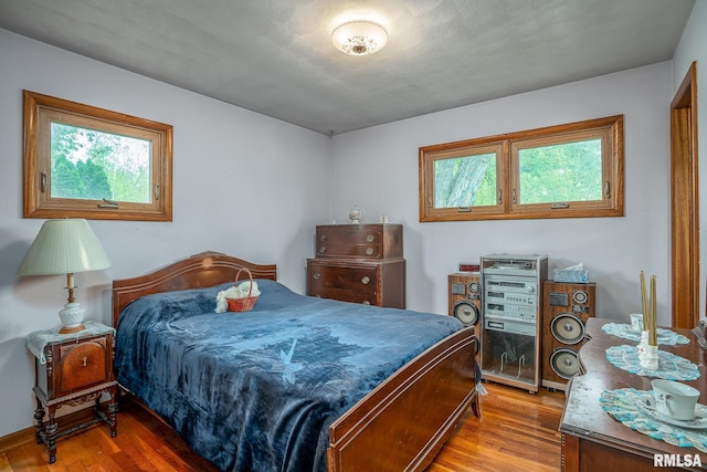 bedroom featuring wood finished floors