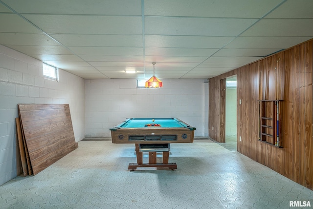 recreation room featuring concrete block wall, tile patterned floors, wood walls, a paneled ceiling, and billiards