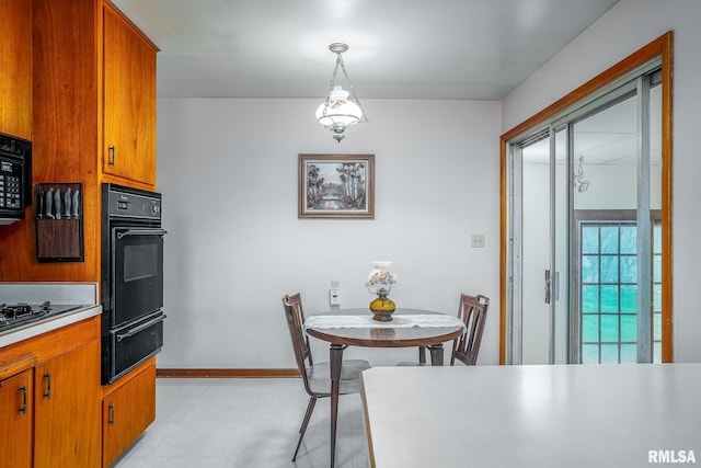 dining room featuring light floors and baseboards
