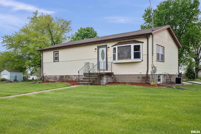 ranch-style home with central AC unit and a front yard