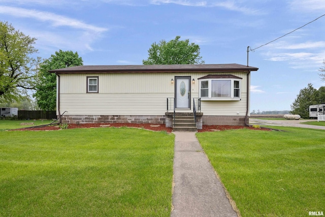 view of front of home featuring entry steps and a front yard