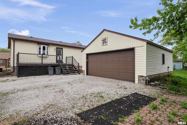view of front facade featuring a detached garage, an outdoor structure, and a deck