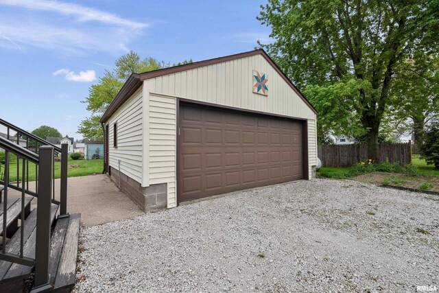 detached garage featuring fence