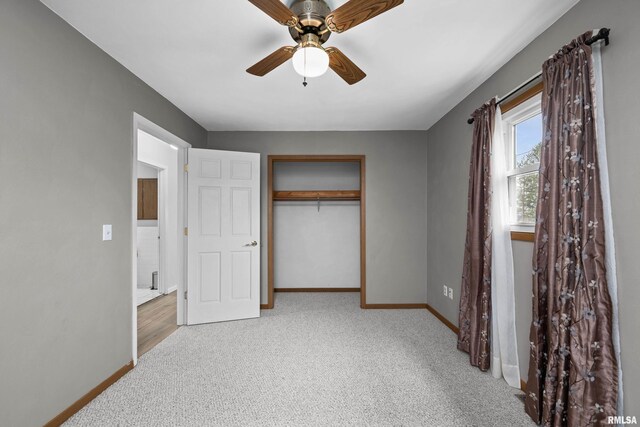 unfurnished bedroom featuring a closet, baseboards, ceiling fan, and carpet flooring