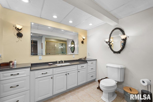 bathroom with a stall shower, vanity, tile patterned floors, toilet, and recessed lighting