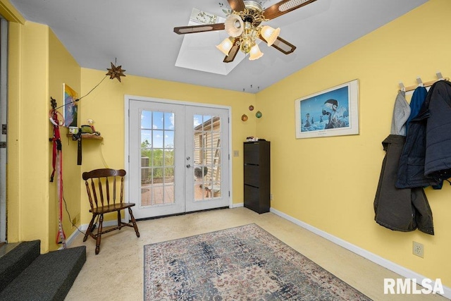 doorway with ceiling fan, french doors, a skylight, baseboards, and carpet