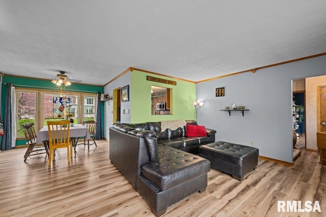 living area with ceiling fan, ornamental molding, and wood finished floors