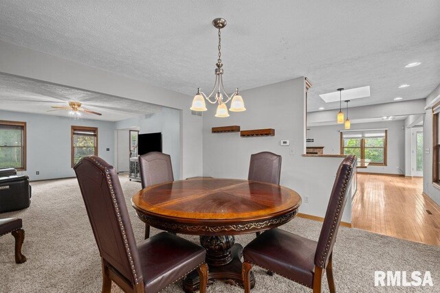 dining room featuring recessed lighting, a textured ceiling, light colored carpet, and ceiling fan with notable chandelier