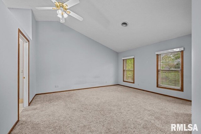 unfurnished bedroom with visible vents, baseboards, vaulted ceiling, and carpet