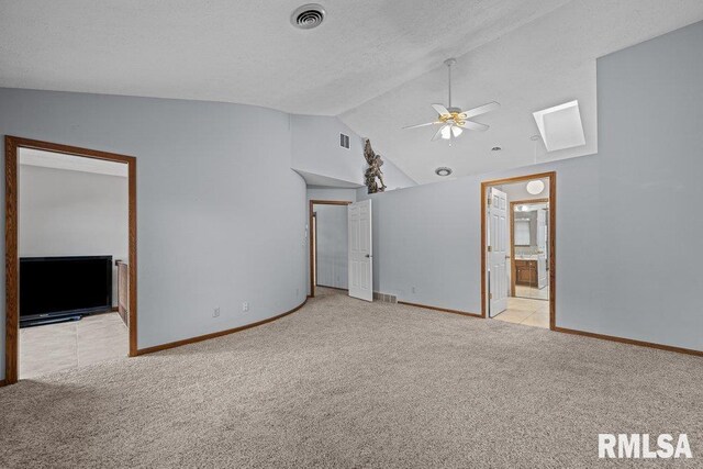interior space with visible vents, a ceiling fan, lofted ceiling, and light colored carpet