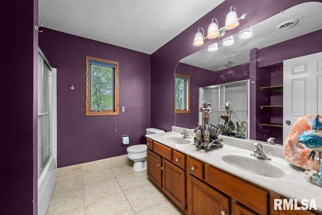 full bath featuring double vanity, toilet, tile patterned floors, and a sink
