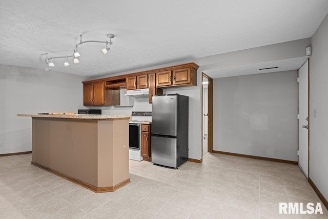 kitchen featuring brown cabinetry, white range with electric cooktop, baseboards, freestanding refrigerator, and under cabinet range hood