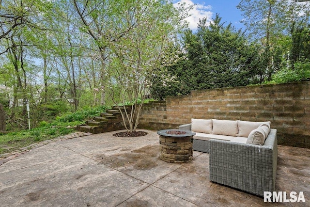 view of patio featuring an outdoor living space with a fire pit