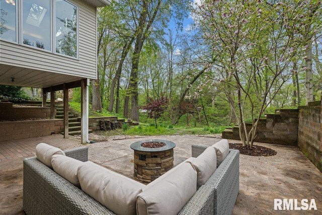 view of patio featuring an outdoor living space with a fire pit and stairway