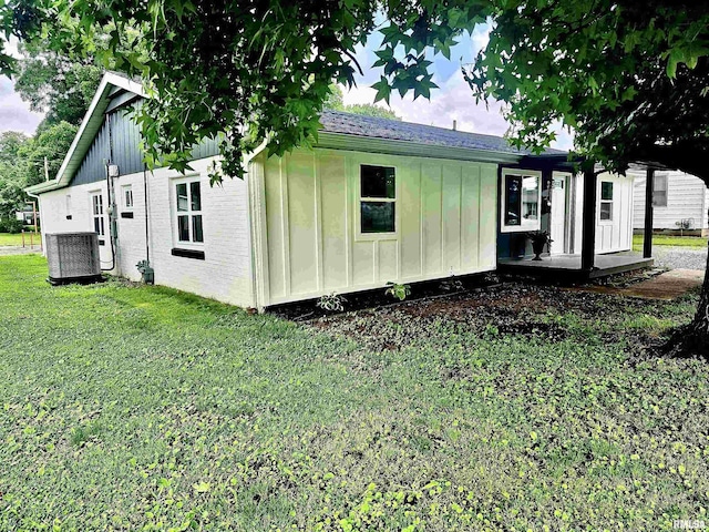 116 Ballantine St, Duquoin, IL 62832 - view of home's exterior with board and batten siding and a yard