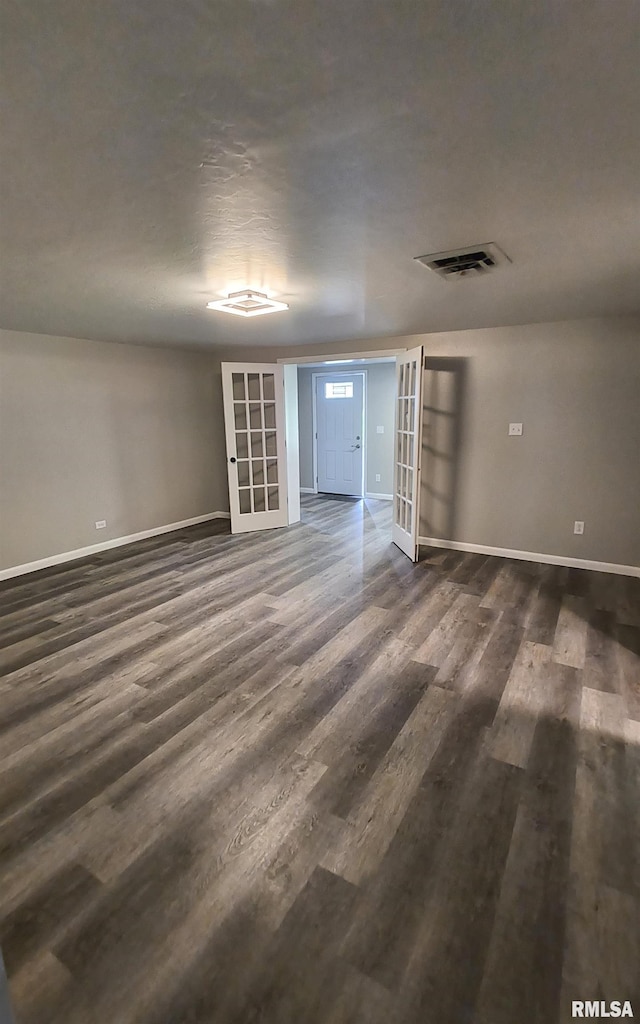 116 Ballantine St, Duquoin, IL 62832 - empty room featuring french doors and dark wood-style flooring