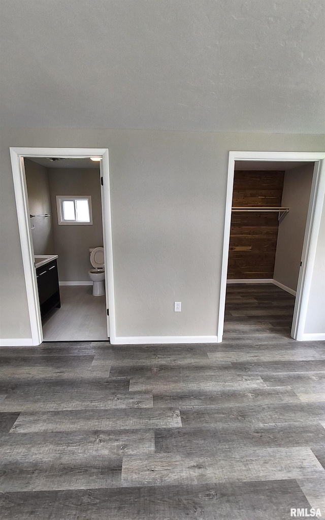 116 Ballantine St, Duquoin, IL 62832 - unfurnished bedroom with wood finished floors, a spacious closet, a closet, and connected bathroom