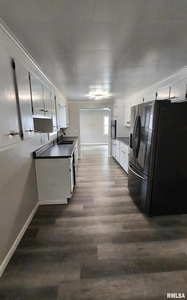 116 Ballantine St, Duquoin, IL 62832 - kitchen featuring fridge with ice dispenser, dark countertops, dark wood finished floors, stainless steel oven, and white cabinets
