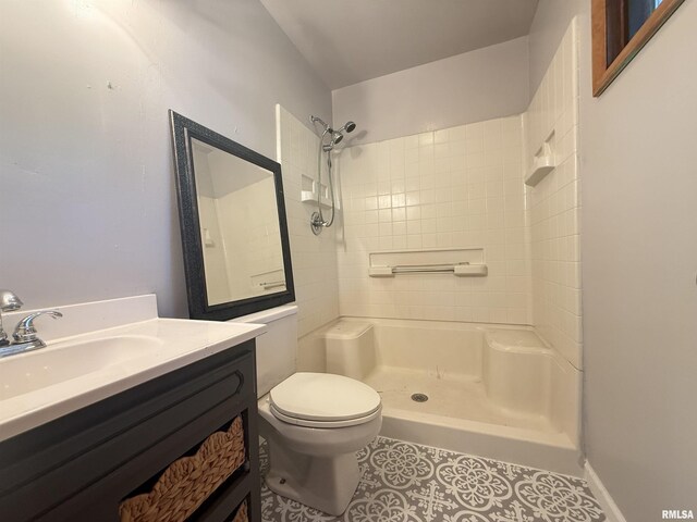 2000 W Gray Dr, Carbondale, IL 62901 - bathroom featuring vanity, walk in shower, tile patterned floors, and toilet