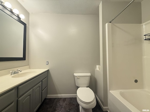 2000 W Gray Dr, Carbondale, IL 62901 - bathroom featuring washtub / shower combination, vanity, toilet, a textured ceiling, and baseboards