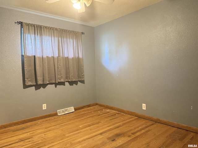 2000 W Gray Dr, Carbondale, IL 62901 - unfurnished room featuring a ceiling fan, baseboards, visible vents, and wood finished floors
