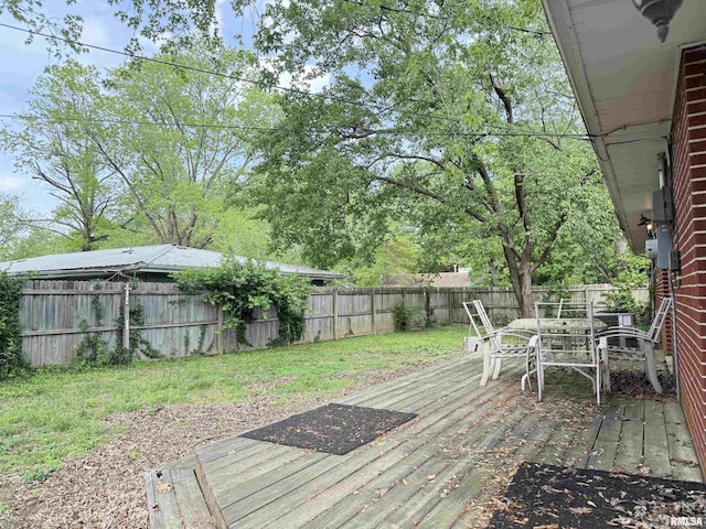 2000 W Gray Dr, Carbondale, IL 62901 - wooden terrace featuring a lawn, outdoor dining area, and a fenced backyard