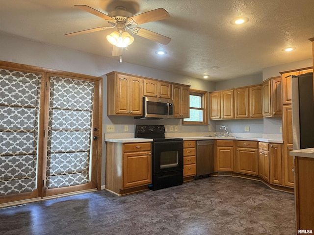 2000 W Gray Dr, Carbondale, IL 62901 - kitchen featuring brown cabinetry, a ceiling fan, appliances with stainless steel finishes, light countertops, and a sink