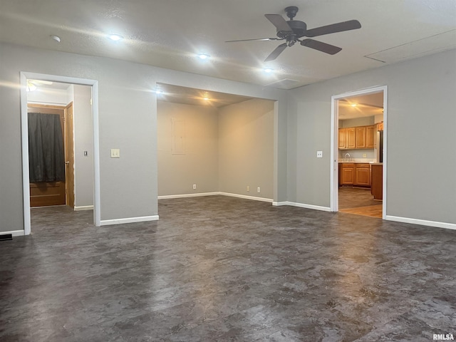 2000 W Gray Dr, Carbondale, IL 62901 - unfurnished living room with baseboards, a ceiling fan, and finished concrete floors