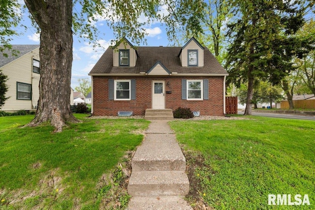 cape cod home featuring a front lawn and brick siding