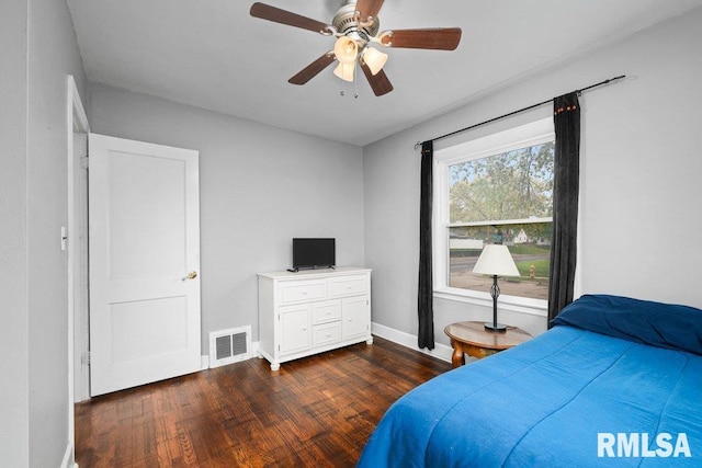 bedroom featuring visible vents, baseboards, ceiling fan, and dark wood-style floors