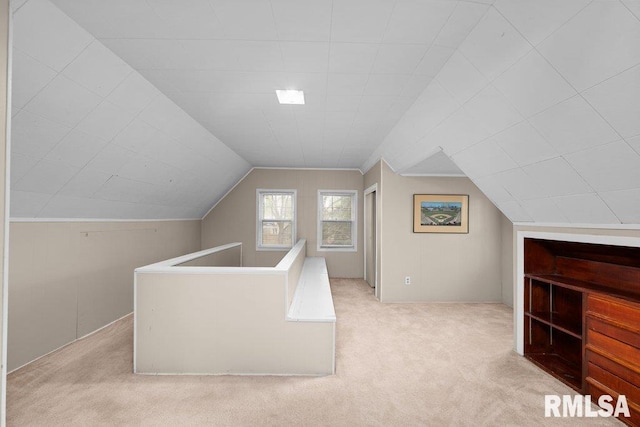 bonus room with vaulted ceiling and carpet flooring