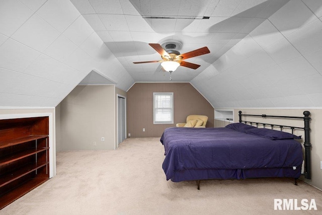 bedroom featuring a ceiling fan, carpet, and vaulted ceiling