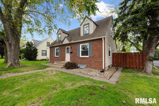 cape cod-style house featuring fence, a front yard, and brick siding