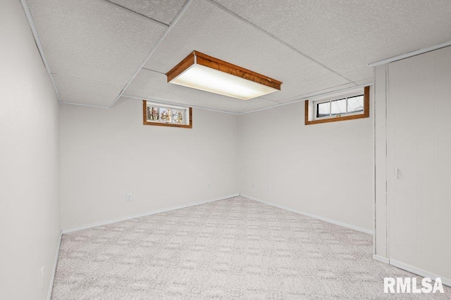 basement featuring baseboards and carpet