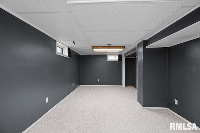 below grade area with plenty of natural light, carpet, and baseboards