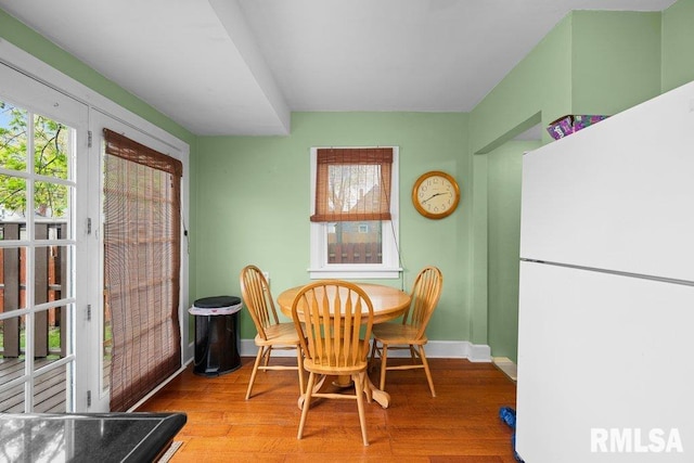dining room featuring baseboards and wood finished floors
