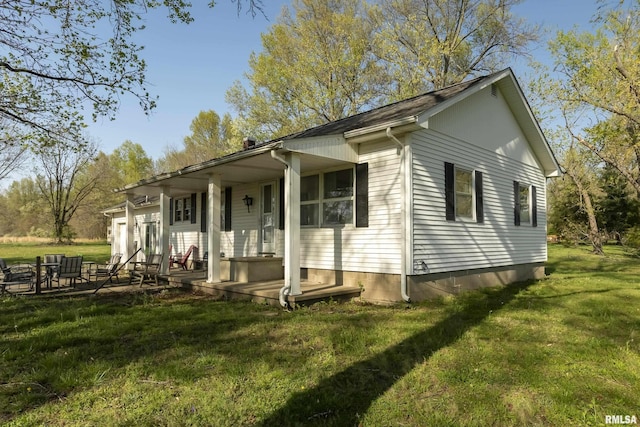exterior space with covered porch and a front yard
