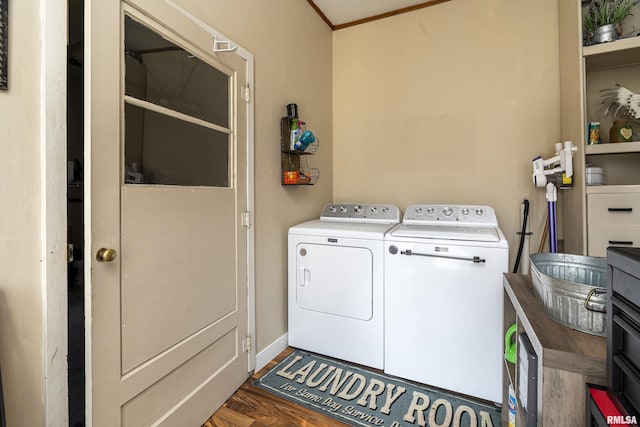 clothes washing area with separate washer and dryer, laundry area, and dark wood finished floors