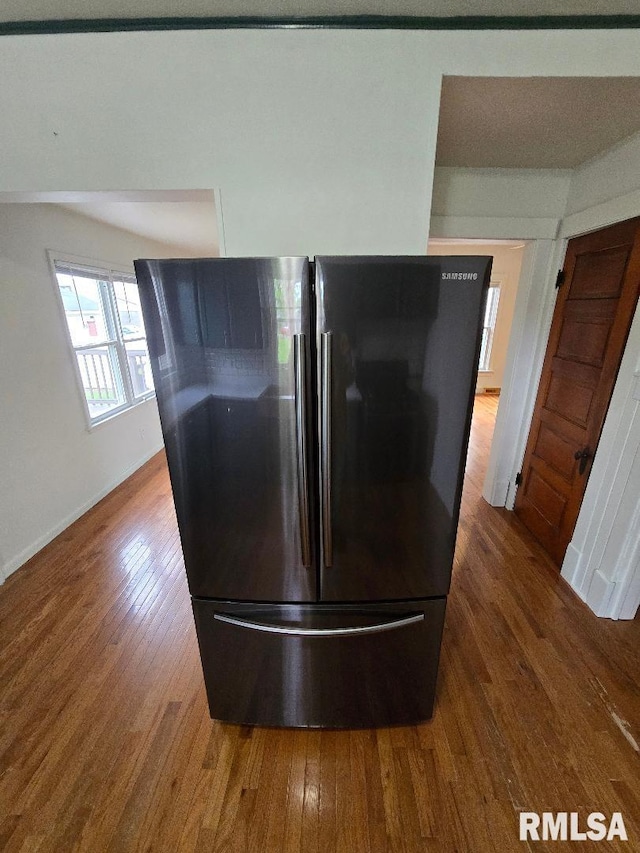 details featuring freestanding refrigerator, baseboards, and wood finished floors