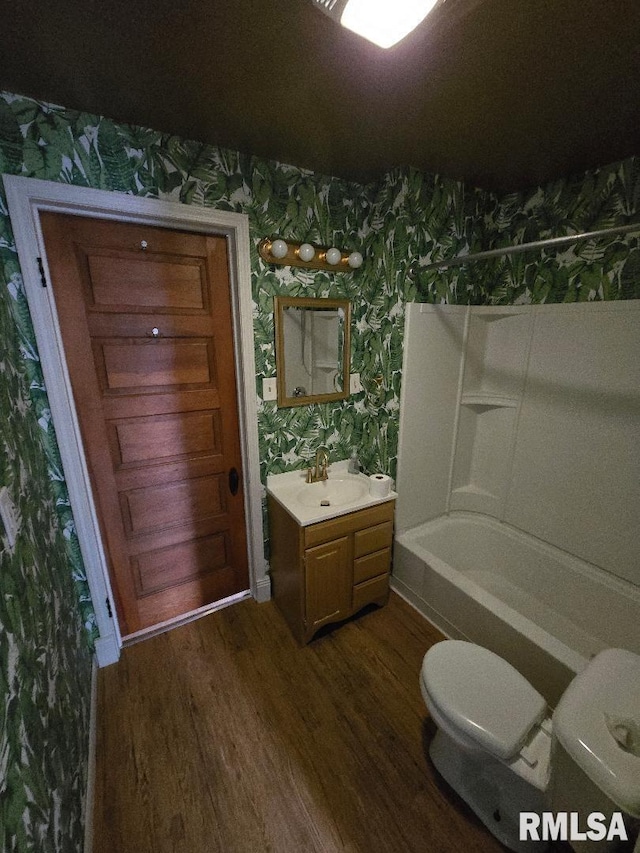 full bathroom featuring shower / bath combination, toilet, wallpapered walls, and wood finished floors