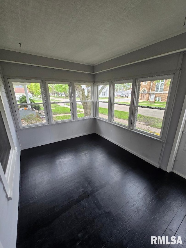 unfurnished sunroom with wood-type flooring