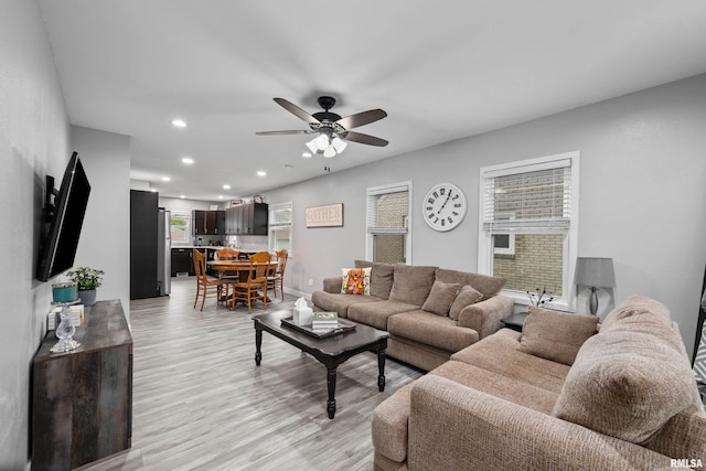 living room with light wood-style floors, recessed lighting, baseboards, and ceiling fan