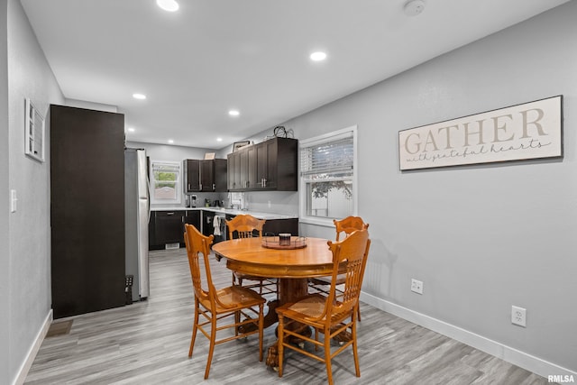 dining space featuring recessed lighting, baseboards, and light wood-type flooring